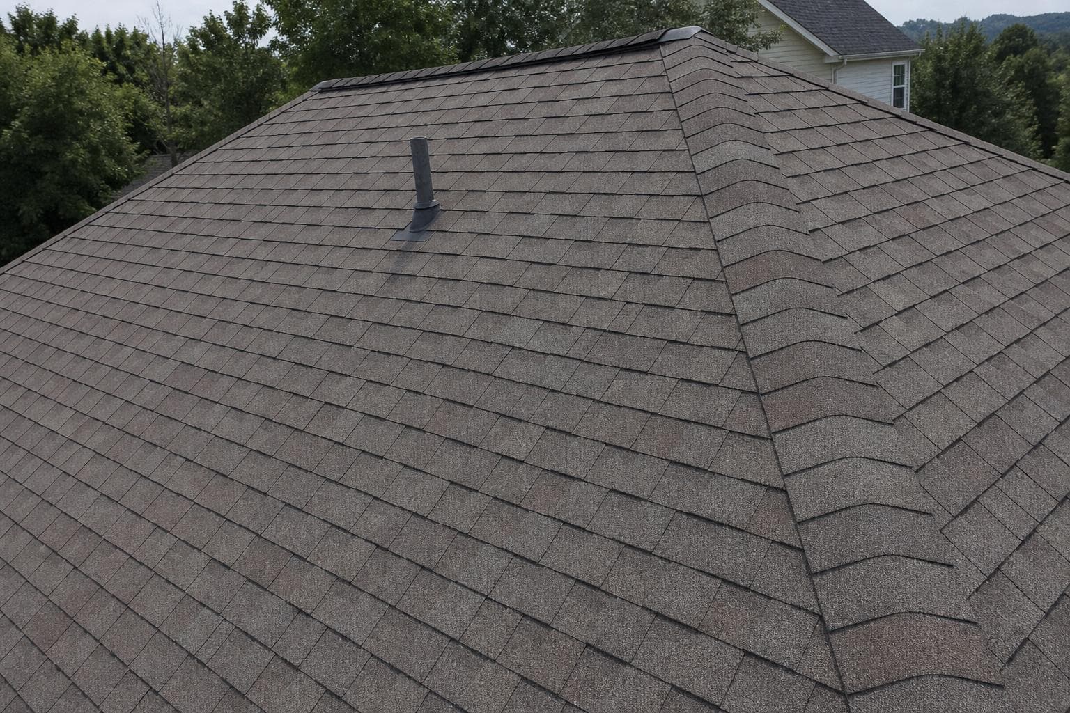 Close-up of gray architectural asphalt shingles on a pitched residential roof